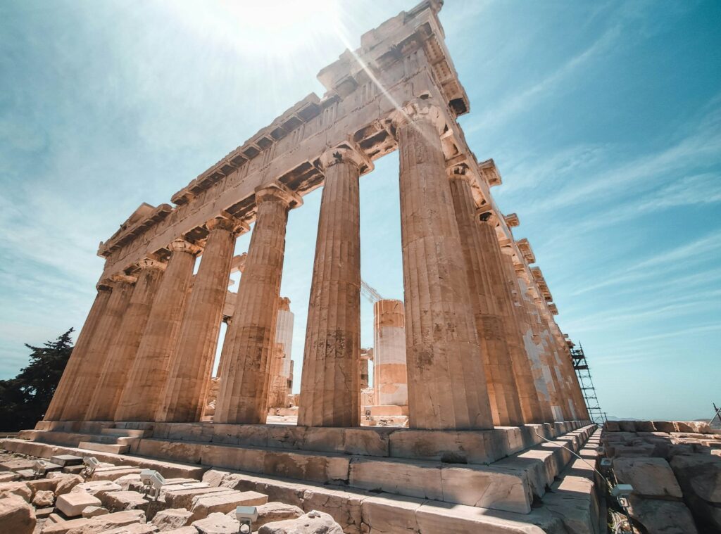the sun shines brightly on the ruins of a temple