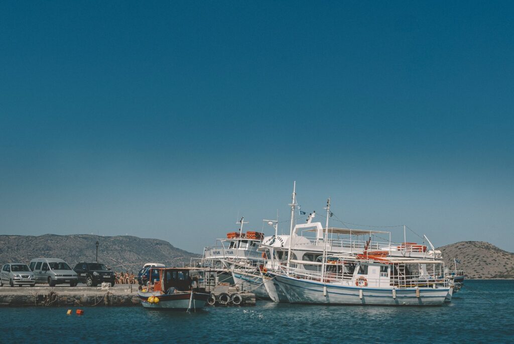 white and red boat on sea during daytime
